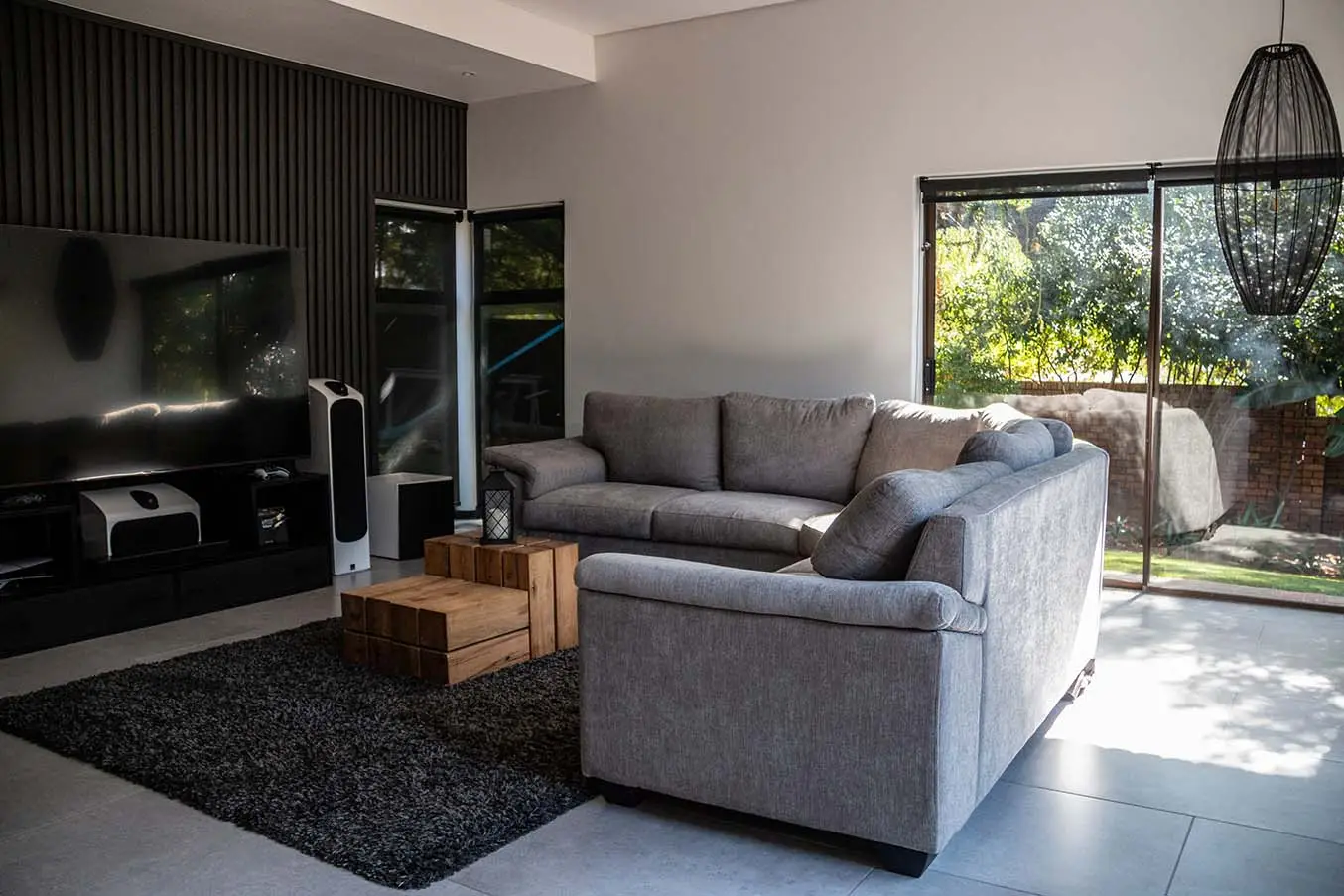 Aurora living room with broad garden-facing sliding glass doors